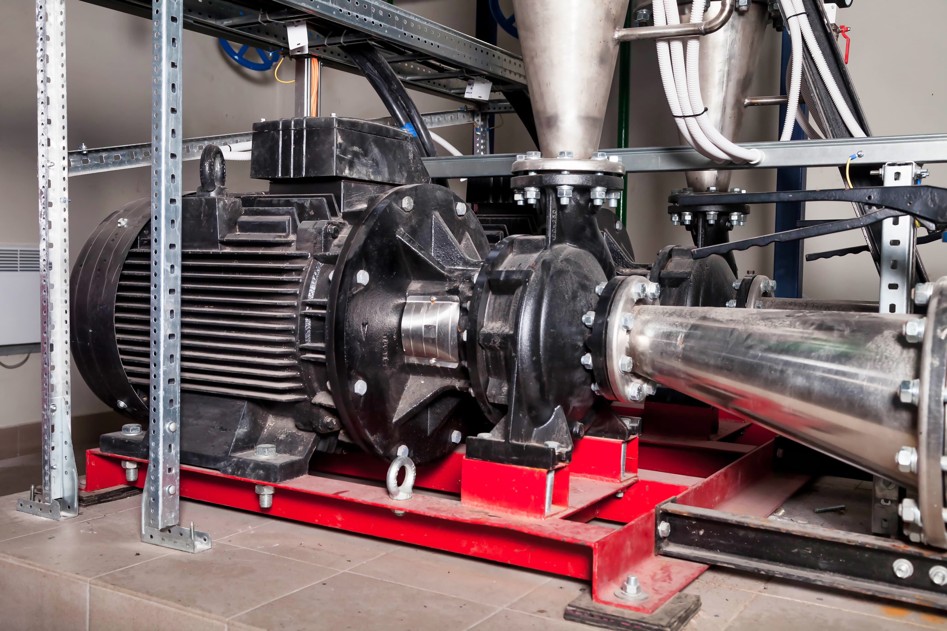 Heavy-duty pump and motor assembly housed in an industrial plant room