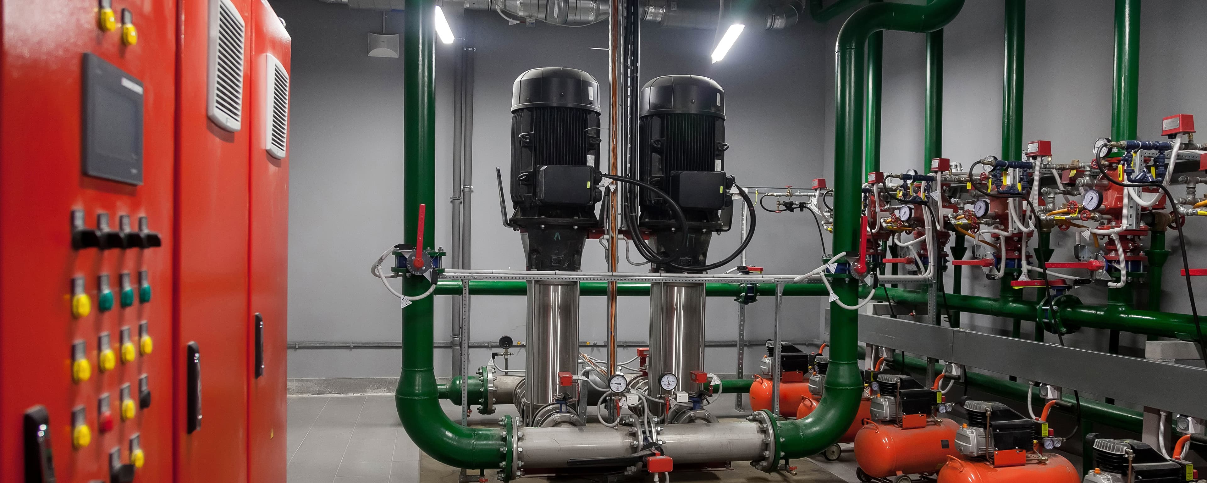Water pumps connected to an automatic control system in a bright industrial engine room